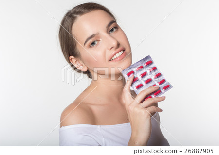 Girl is holding medicaments in hands Girl is holding medicaments in hands 26882905