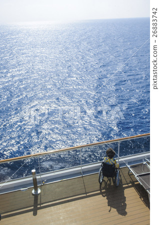 Disabled woman in wheelchair on the deck of cruise Disabled woman in wheelchair on the deck of cruise 26883742