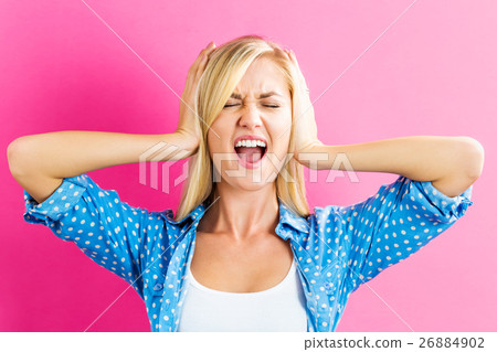 A woman who is blocking her ears A woman who is blocking her ears 26884902
