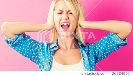A woman who is blocking her ears 26884903