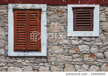 Textured wall with orange shutters 26888800