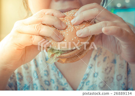 Asia woman eating a hamburger Asia woman eating a hamburger 26889134