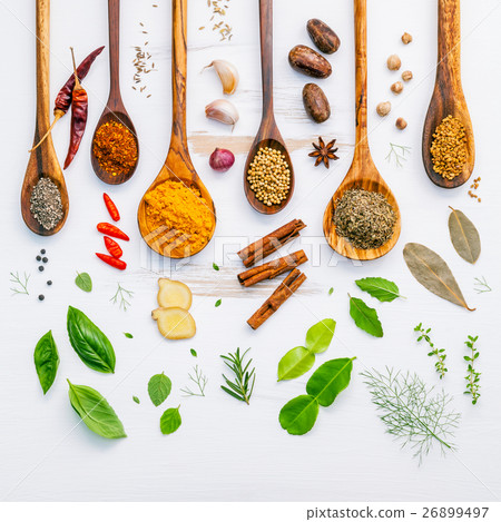 Various herbs and spices in wooden spoons. 26899497