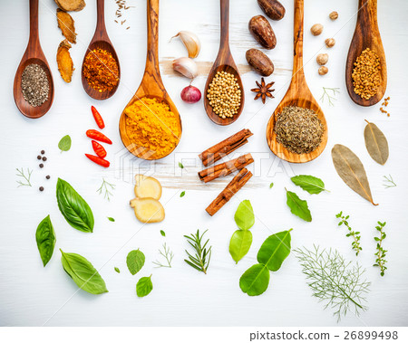 Various herbs and spices in wooden spoons. 26899498