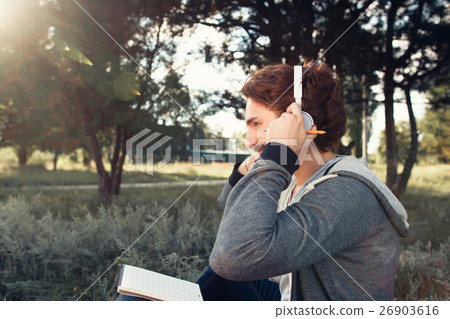 Man wearing headphones, relaxing at nature Man wearing headphones, relaxing at nature 26903616