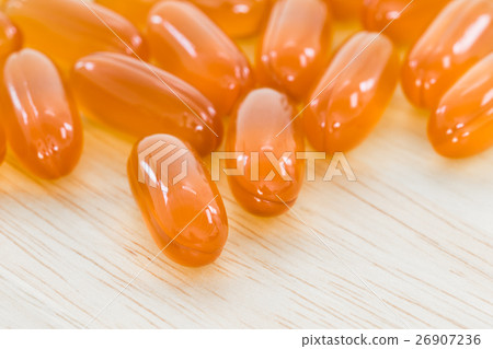 Close up Gel capsule on wooden table Close up Gel capsule on wooden table 26907236