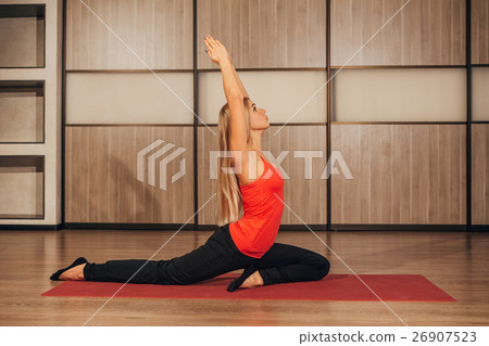 woman in a traditional yoga pose woman in a traditional yoga pose 26907523