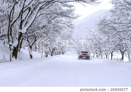 Car and falling snow in winter on forest road. Car and falling snow in winter on forest road. 26908877