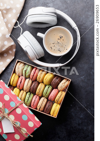 Colorful macaroons in a gift box and headphones Colorful macaroons in a gift box and headphones 26909653