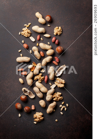Various nuts on stone table 26909693