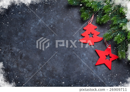 Christmas fir tree and decor over stone background Christmas fir tree and decor over stone background 26909711