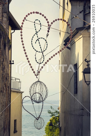 Treble clef in heart lighting with Lago di Garda  26910035