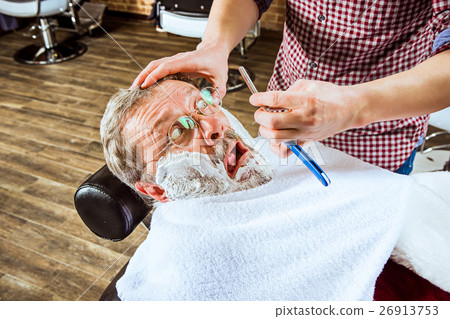 The senior man visiting hairstylist in barber shop 26913753