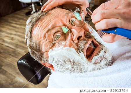 The senior man visiting hairstylist in barber shop The senior man visiting hairstylist in barber shop 26913754