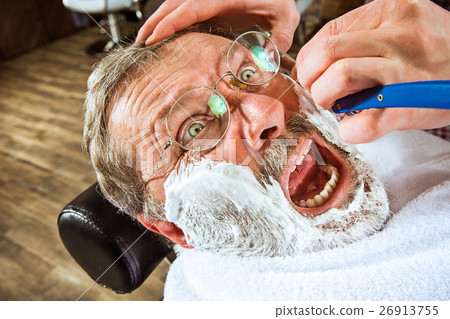 The senior man visiting hairstylist in barber shop The senior man visiting hairstylist in barber shop 26913755