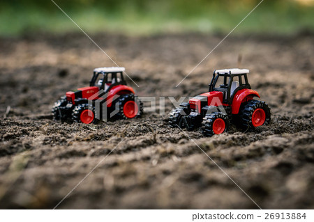 Toy tractors on the field Toy tractors on the field 26913884