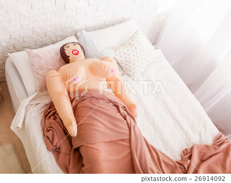 Sex doll lies under blanket on bed. - Stock Photo [26914092] - PIXTA