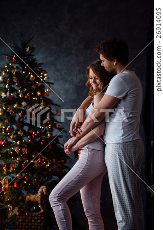 Beautiful young couple in pajamas on nicely 26914095