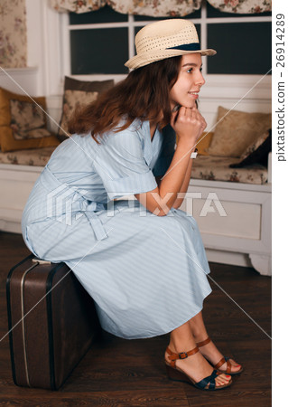 Vintage travelling concept with a young woman. Vintage travelling concept with a young woman. 26914289
