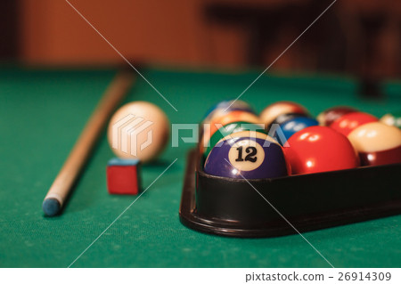 Billiard balls near by cue and chalk. 26914309