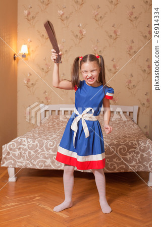 Little girl with belt in hand. 26914334