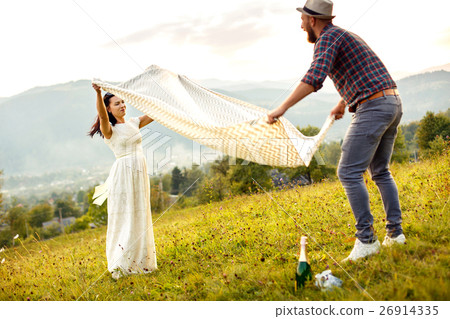 couple in love preparing for picnic. spread white couple in love preparing for picnic. spread white 26914335