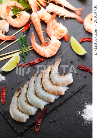 Raw and boiled shrimps on a stone plate Raw and boiled shrimps on a stone plate 26914436