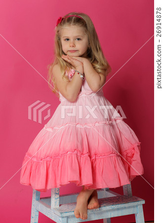 Portrait of baby posing on chair. Pink background Portrait of baby posing on chair. Pink background 26914878