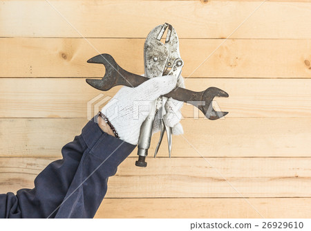 Hand holding Spanner and Adjustable wrench 26929610