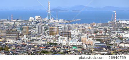 Look down Saijo city from the south to the north. In the center you can see the Kurushima Kaikyo Bridge across the city hall and the station, Nakundada. 26940769