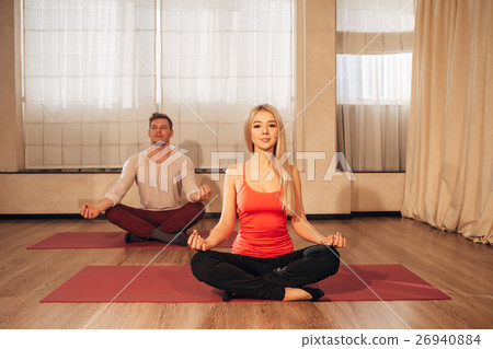 slim female and man on background meditating in 26940884