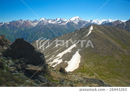 Green grassy mountain valley with ice peaks Green grassy mountain valley with ice peaks 26943263