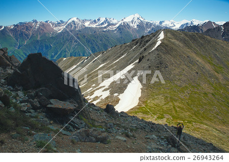Hiker trekking in the mountains. Hiker trekking in the mountains. 26943264