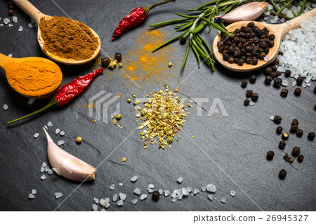 Stock Photo: spices and herbs over black stone background