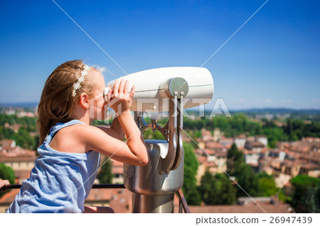 Beautiful little girl looking at coin operated 26947439