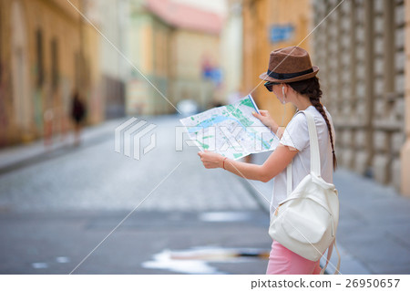 Beautiful woman looking at touristic citymap in Beautiful woman looking at touristic citymap in 26950657