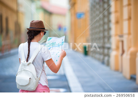 Happy young woman with a city map in city. Travel Happy young woman with a city map in city. Travel 26950658