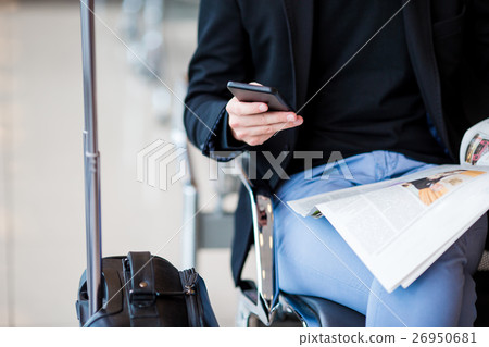Young caucasian man with newspaper at the airport Young caucasian man with newspaper at the airport 26950681