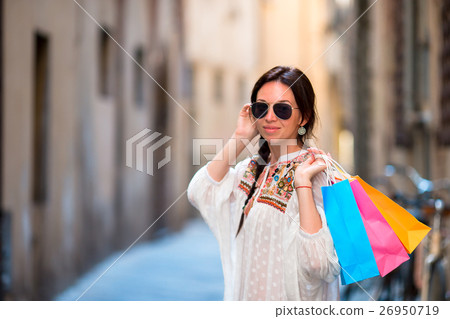 Young girl with shopping bags on narrow street in Young girl with shopping bags on narrow street in 26950719
