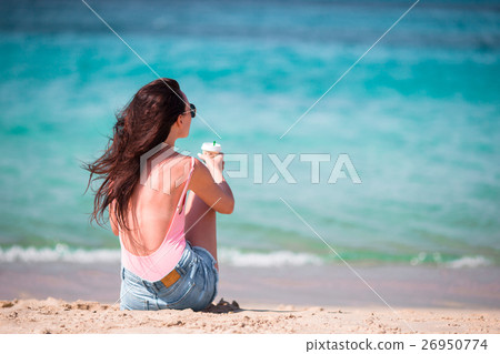 Young beautiful woman with coffee on the beach Young beautiful woman with coffee on the beach 26950774