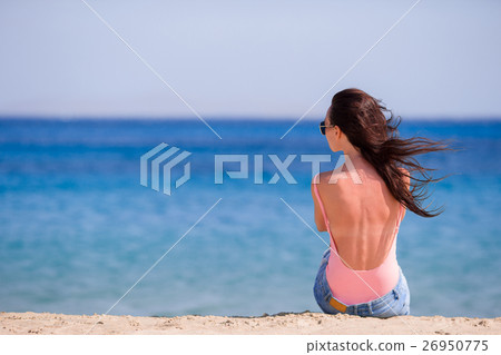 Young beautiful woman with coffee on the beach Young beautiful woman with coffee on the beach 26950775