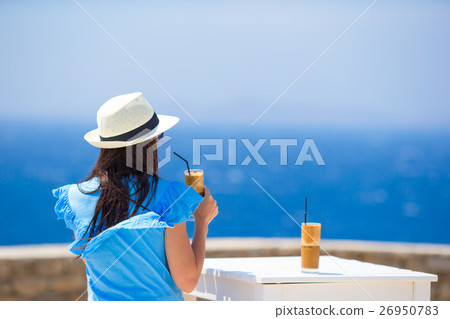 Back view of woman drinking cold coffee enjoying Back view of woman drinking cold coffee enjoying 26950783
