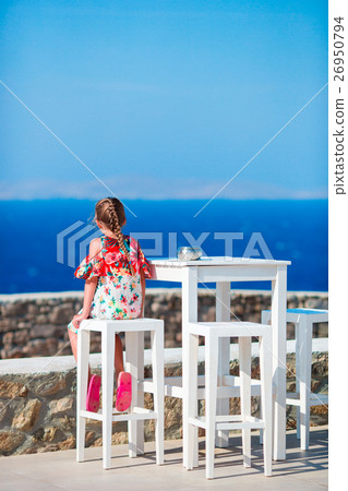 Adorable little girl having breakfast at outdoor Adorable little girl having breakfast at outdoor 26950794