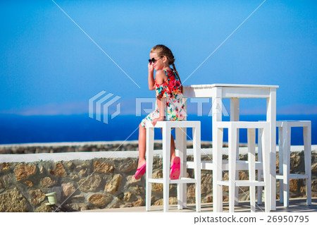 Kid sitting in outdoor cafe with sea view. Time Kid sitting in outdoor cafe with sea view. Time 26950795