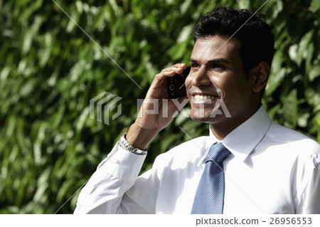 Cropped shot of  Indian man talking on phone and smiling 26956553