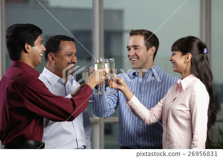 Mixed raced group toasting eachother 26956831