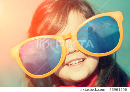 little girl with big sunglasses looking at the sun 26961306