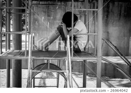 Girl pauper sitting alone at playground,black and white tone Girl pauper sitting alone at playground,black and white tone 26964042