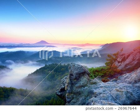 Misty awaking of fairy valley.Peaks of rocks above Misty awaking of fairy valley.Peaks of rocks above 26967644