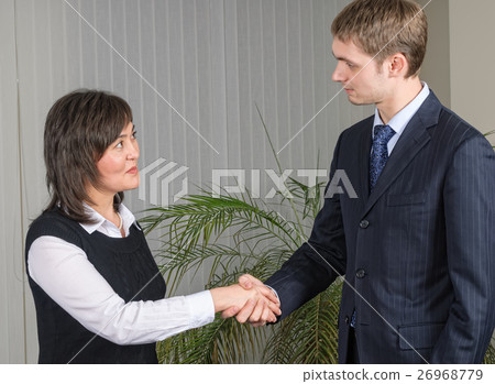 Two businesspeople handshaking 26968779